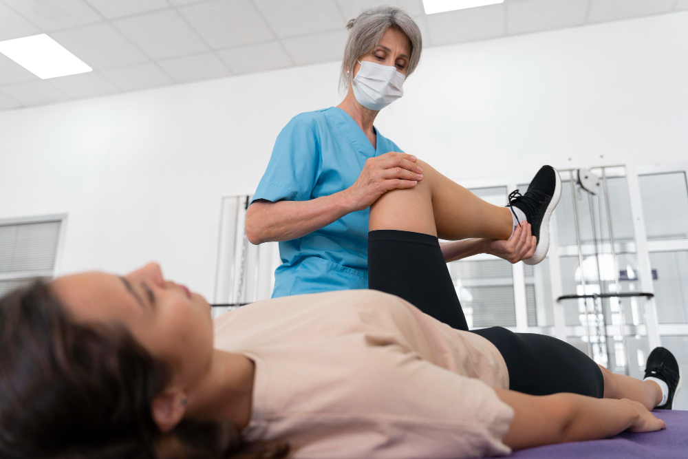 medical assistant helping patient with physiotherapy exercises
