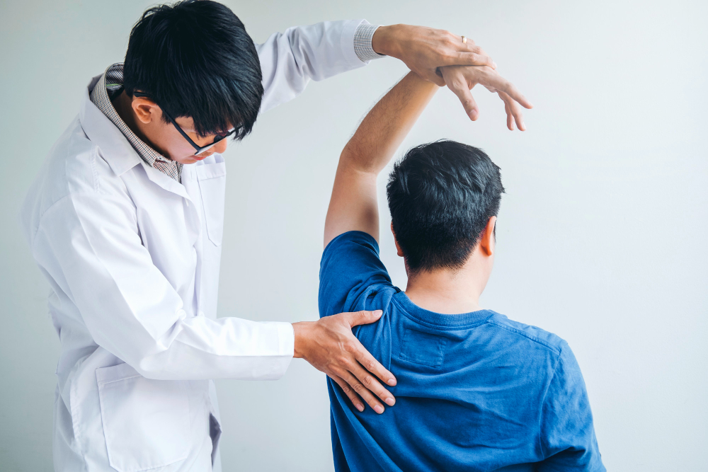 physical doctor consulting with patient about shoulder muscule pain problems