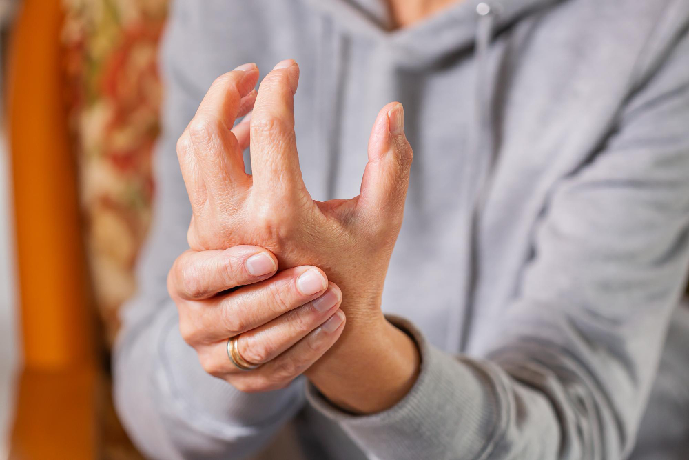 senior woman suffering from hand finger joint pain inflammation