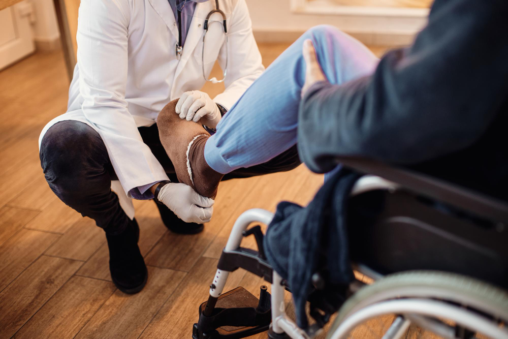 unrecognizable doctor examining leg senior patient nursing home